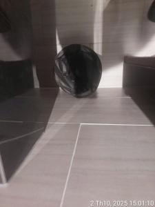 a black object sitting on a tile floor at Sulina Hlels 4 in Ho Chi Minh City