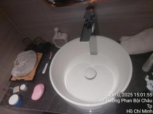 a bathroom with a white toilet in a room at Sulina Hlels 4 in Ho Chi Minh City