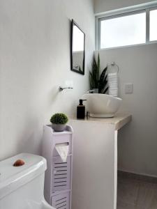 a bathroom with a sink and a toilet at La Casa del Café - Mesa de Juegos y Comfort in Comitán +52 photos
