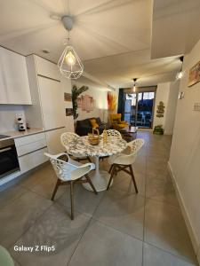 a kitchen and dining room with a table and chairs at Buddha house in Torrox Costa