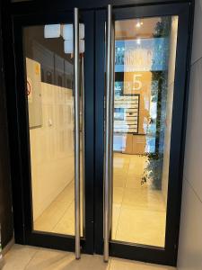 a glass door of a store with a basketball court at New Apartment CRISTAL in the city centre in Novi Sad