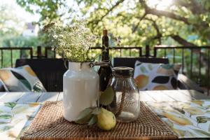 a table with two bottles and a vase with flowers at Erdőalján Házikó in Sukoró +18 photos