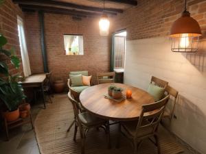 a dining room with a wooden table and chairs at Ethlyn House in Bocas del Toro +9 photos