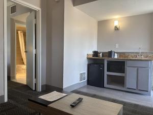 a kitchen with a sink and a counter top at SureStay InnSuites Phoenix Hotel & Suites by Best Western in Phoenix
