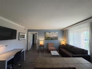a living room with a couch and a tv at SureStay InnSuites Phoenix Hotel & Suites by Best Western in Phoenix