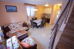 a living room with a table and a dining room at Žanjice Luxury Suite in Luštica