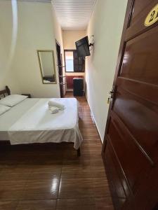 Ένα ή περισσότερα κρεβάτια σε δωμάτιο στο Suítes Florais - Itaguá