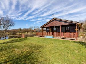 a large wooden house with a large yard with a house at 3 Bed in Clovelly 00372 in Clovelly +8 photos