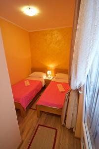 a room with two beds and a window at Žanjice Luxury Suite in Luštica