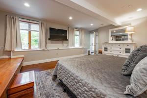 a bedroom with a bed and a flat screen tv at Blue Anchor in Swanton