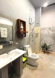 a bathroom with a toilet and a sink and a shower at Wind Villa Weligama in Weligama