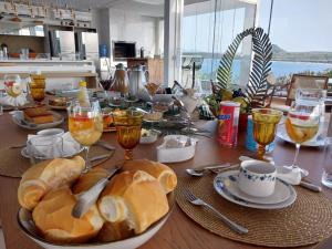 a table with a plate of bread and wine glasses at Casa da Orla in Santarém
