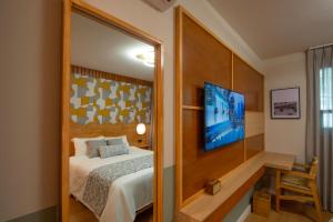 a bedroom with a bed and a large mirror at Hotel Boutique Casa Flor de Café in Mexico City