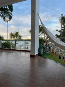 a room with a view of the ocean and a hammock at Casa da Orla in Santarém
