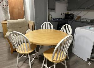 a wooden table and four chairs in a kitchen at Broad Oak Stays 2BR Flat for 6 with Parking in Brede