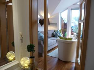a living room with a couch and a large mirror at Holiday Apartment Northern Lights in Oldenburg