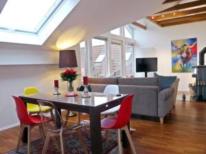 a living room with a table and chairs and a couch at Holiday Apartment Northern Lights in Oldenburg