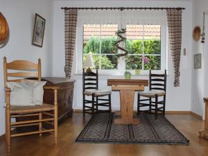 a living room with a table and chairs and a window at Holiday apartment with 2 bedrooms in Bad Zwischenahn