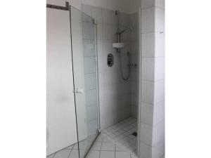 a shower with a glass door in a bathroom at Holiday apartment with 2 bedrooms in Bad Zwischenahn +18 photos