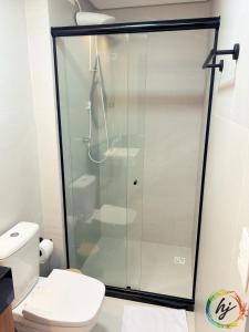 a glass shower in a bathroom with a toilet at Breeze 101 in João Pessoa