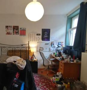 a messy room with a bed and a desk at room 1 vix in Pristina