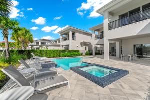 a villa with a swimming pool and a house at The Bear's Den Resort Orlando in Kissimmee