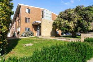 a brick building with a yard in front of it at Black Canvas Lux Getaway in Cottesloe