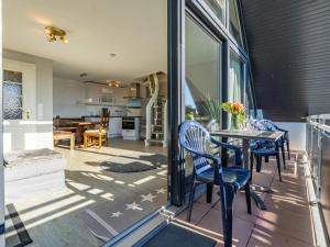 een keuken en eetkamer met een tafel en stoelen bij One-bedroom apartment in Wenningstedt