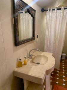 a bathroom with a sink and a mirror at Orion Luxury Desert Camp in Merzouga +58 photos