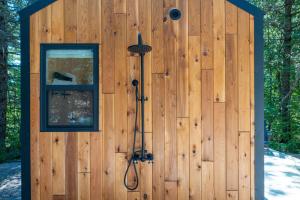 a wooden shed with a shower in it at Luna Nook-Cabin with tub Queen Bed & pullout sofa in Sullivan