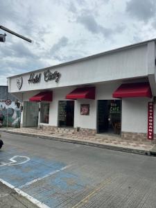 a fast food store with red awnings on a street at Hotel Cadiz Boutique in Santa Rosa de Cabal
