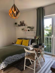 a bedroom with a bed and a table at Apartment Prague Airport- 5 minute drive from AirPort in Tuchoměřice