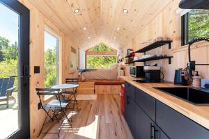 a tiny house with a kitchen and a bedroom at Aurora Nook-Cabin with Shower & Queen Bed in Sullivan