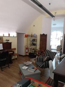a living room filled with furniture and a piano at Al Nido delle rondini 2 in Vaprio dʼAdda