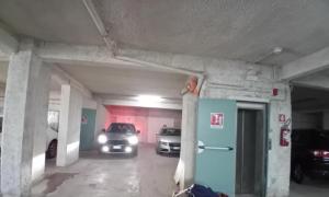 a parking garage with two cars parked in it at Luna Reale Roccaraso apt in Roccaraso