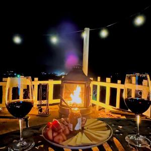 a table with two glasses of wine and a plate of food at Rancho 29 VDG in Ensenada