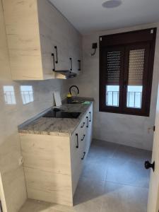 a kitchen with a sink and a counter top at Raíces de Alcalá in Alcalá del Júcar