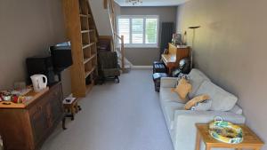 HindheadにあるSelf-contained 2-story accommodation in Grayshottのソファとテレビのあるリビングルーム