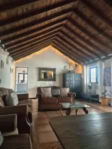 un salon avec un canapé et une table dans l'établissement Detached Villa with Stunning Mountain and Sea Views, 14m Pool & sunken Hot Tub, à Puerto del Carmen