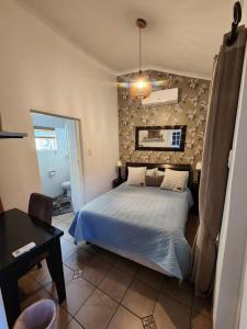 a bedroom with a bed and a wall at Maple Tree Manor in Durban +25 photos