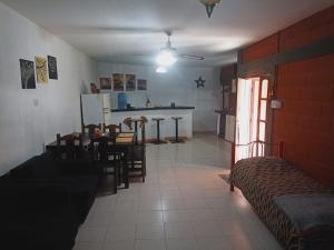 a living room with a couch and a table and chairs at gebalojamientos in San Fernando del Valle de Catamarca