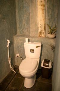 a bathroom with a white toilet in a room at Ayaan Beach Home in Dodanduwa