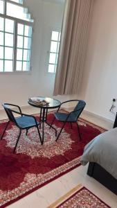 a room with two chairs and a table and a bed at Qantab village room in Muscat +45 photos