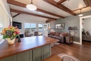a kitchen with a wooden counter top in a living room at Sunny Shores - Lake days, Pool dips & Concerts in Dockham Shore