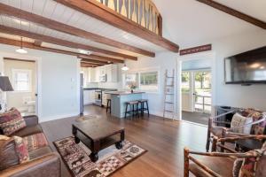 a living room with a couch and a table at Sunny Shores - Lake days, Pool dips & Concerts in Dockham Shore