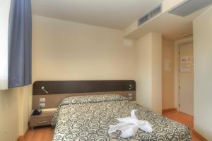 Postel nebo postele na pokoji v ubytování Hotel Pasha