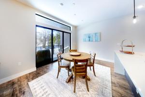 a kitchen and dining room with a table and chairs at River West 811 in Silverthorne