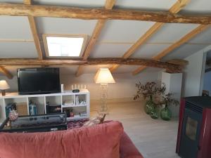 a living room with a couch and a tv at Apartamento Riazón3 in Ourense