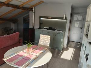 a living room with a table and a kitchen at Apartamento Riazón3 in Ourense +18 photos
