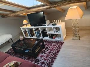 a living room with a tv on a white cabinet at Apartamento Riazón3 in Ourense